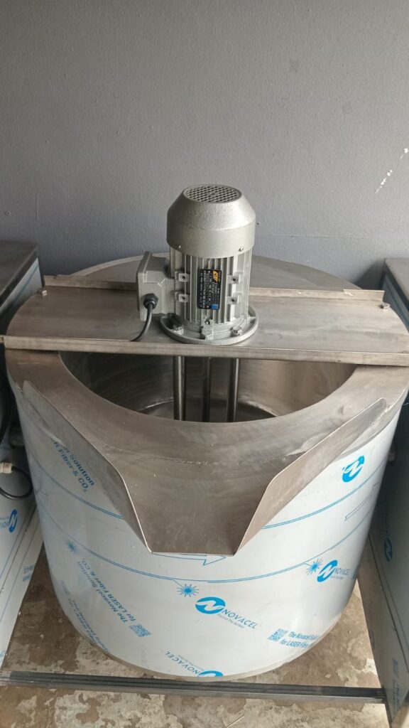 Stainless steel jacketed tilting pot with top-mounted motor and agitator